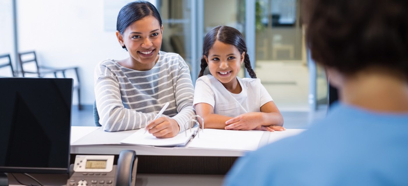 family at dental front desk